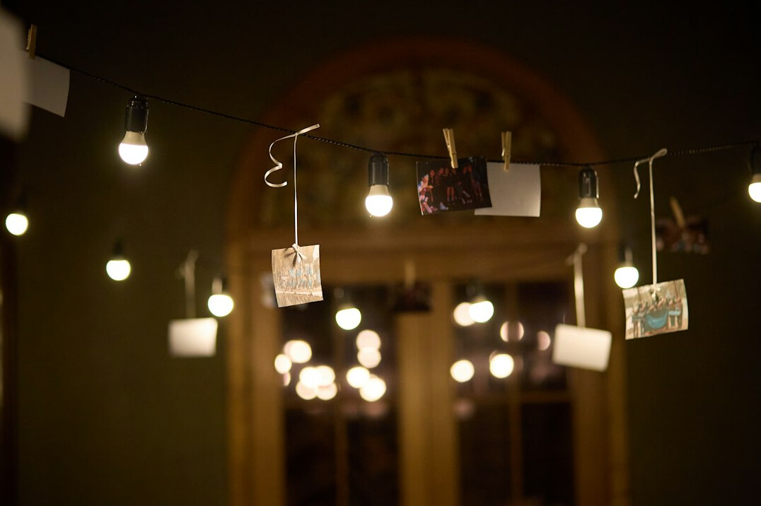 Pinboard with photographs and notes connected by string