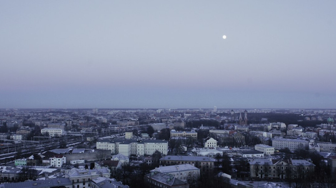 ufo near cityscape at dusk